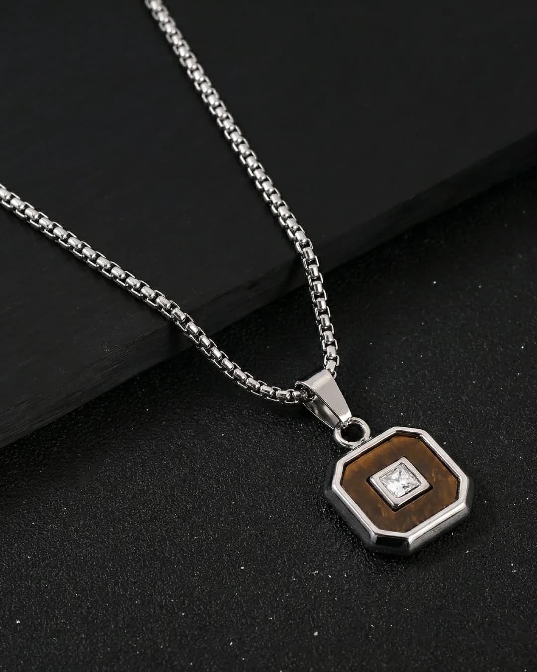 Men’s silver and brown pendant product photograph